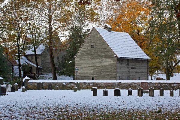 A building in the Ephrata Cloister, PA in the fall lightly covered in snow