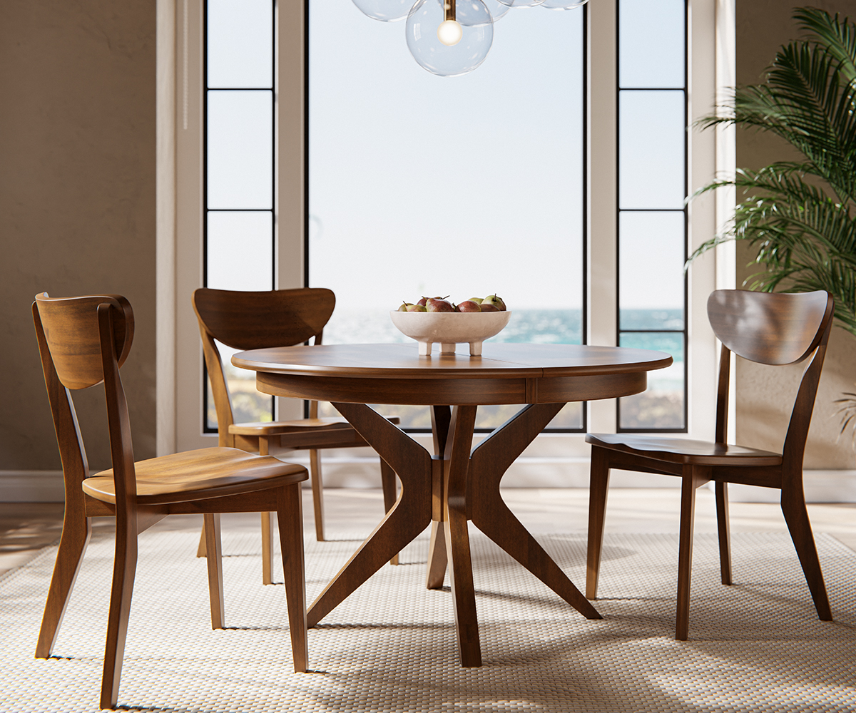 A round wooden dining table with three mid-century modern chairs in brown maple with a cappuccino finish, set in front of large windows with natural light pouring in. A decorative chandelier with multiple glass bulbs hangs above the table, and a potted plant is placed to the side.